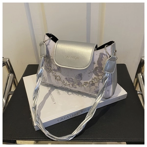 Detail of silver PU leather bag with butterfly prints and flower chain decoration