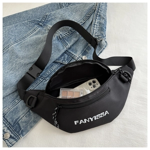 Close-up of black crossbody bag showing spacious interior with phone and makeup kit