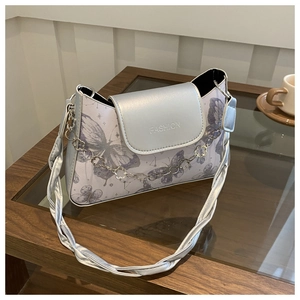 Detail of silver crossbody bag with purple butterfly print and metal flower chain strap