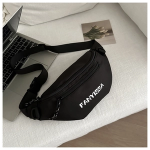 Detail of black nylon fanny pack with white lettering logo on soft white fabric background