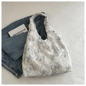Detailed texture of white lace canvas tote bag with elegant grey butterfly patterns