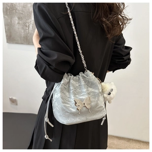 Silver drawstring bucket bag with butterfly plaque and cat charm on chain strap