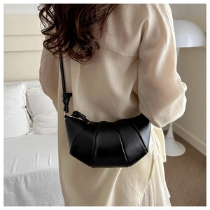 Vue détaillée du dos d'un sac à bandoulière croissant noir avec nœud décoratif
