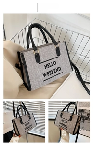 Detail of canvas tote bag featuring black leather trim and HELLO WEEKEND text print