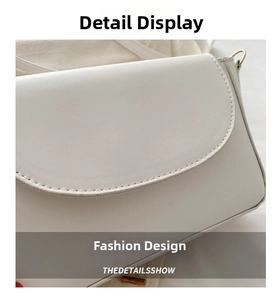 Detail shot of the cream white leather bag showing precise stitching and golden metal hardware