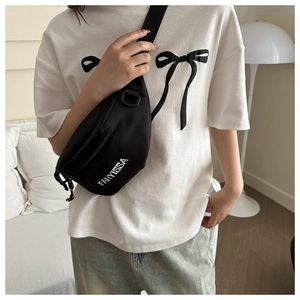 Detail of black nylon crossbody bag with FANYISSA logo and adjustable fabric strap