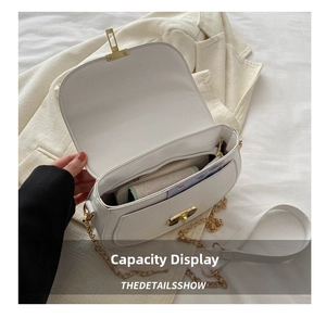 Internal view showing capacity of the white half-moon bag with zipper pocket