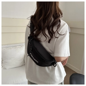 Detailed view of black nylon shoulder bag with FANYISSA logo and adjustable strap