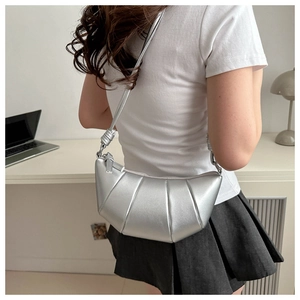 Gros plan du sac croissant argenté avec texture plissée métallique et forme en arc