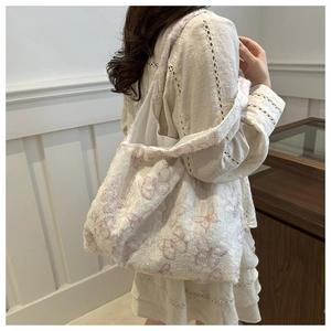Close-up of white lace texture and pink butterfly pattern on large capacity tote bag