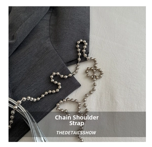 Close-up of a glossy silver beaded metal chain strap for stylish crossbody bags