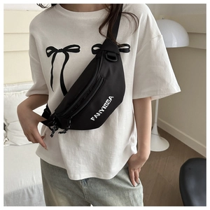 Detail of FANYISSA black canvas crossbody bag showing letter print and adjustable strap