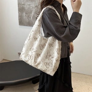 White canvas tote bag with brown butterfly prints and fringe edges for casual wear