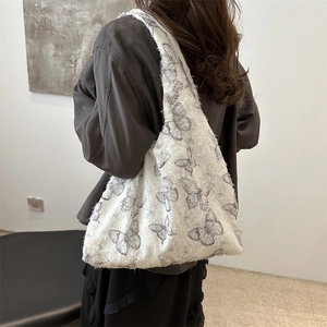 Minimalist white canvas tote bag with artistic butterfly prints and stylish frayed edges