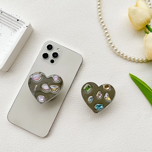 Silver mirror heart-shaped phone grip stand with colorful rhinestone gem embellishments