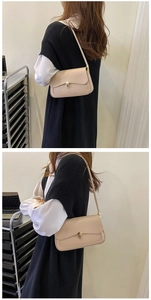 Detailed view of a chic beige underarm bag with a premium golden square metal clasp