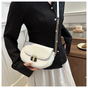 Close-up of white semi-circular crossbody bag with black gold clasp and chain strap