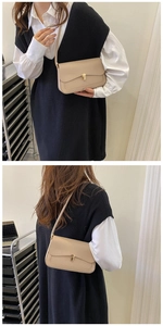 Detail view of beige crossbody bag with gold twist lock and slim shoulder strap
