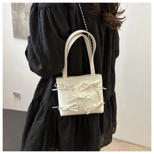 White faux leather bucket bag with 3D bows and silver chain strap for women