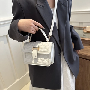 Elegant white quilted crossbody bag with gold hardware buckle and top handle for women