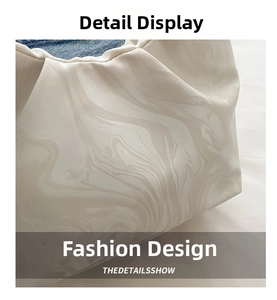 Detail of pleated marble texture bucket bag with denim lining and minimalist design