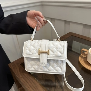 Elegant white quilted crossbody bag with gold buckle and top handle for women