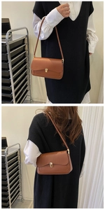 Detail of caramel leather shoulder bag featuring a vintage gold clasp and matte finish