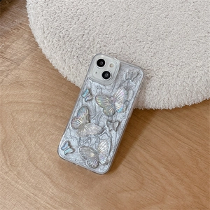 Detailed macro of iPhone case with silver glitter texture and 3D pearl butterflies