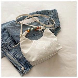 Detail of marble pattern white PU leather hobo bag with colorful resin beaded handle