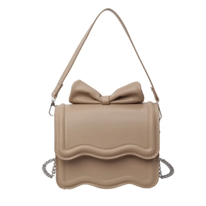Beige faux leather crossbody bag with a large bow detail and stylish wavy edge cover