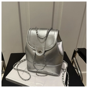 Detail of silver metallic textured mini backpack with silver twist lock and chain strap