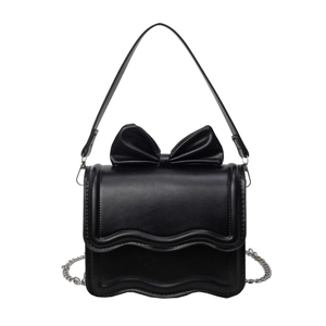 Elegant black leather bow handbag with wavy edges and silver chain strap for women