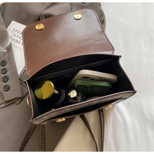 Interior view showing the capacity of a brown vintage crossbody bag with magnetic closure
