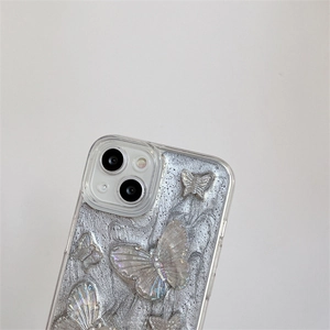 Detailed view of silver glitter phone case with 3D aurora butterfly ornaments for iPhone