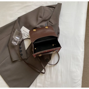 Detailed interior of vintage plaid flap backpack with black lining and magnetic closure