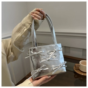 Metallic silver PU leather handbag featuring five 3D bows and a dual handle design