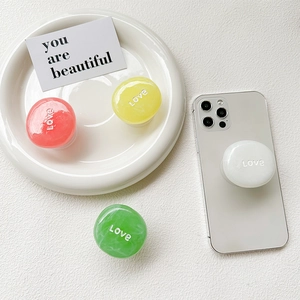 Colorful expandable phone grip marble texture and Love engraving on white smartphone