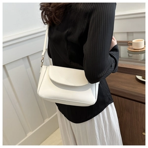 Detail of white matte synthetic leather shoulder bag with golden metal hook closure
