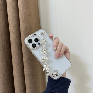 Detailed view of luxury iPhone case featuring sparkling rhinestone leaf chain accessory
