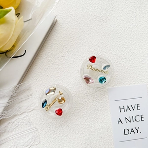 Macro detail of two circular Griptoks featuring colorful rhinestones and gold Diamonds text
