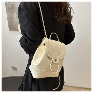 Detail of cream white leather backpack with chain strap and metal turn-lock closure