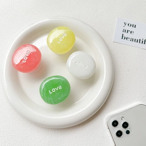 Close-up of colorful marble texture Love phone grips on a white ceramic tray