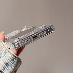 Detailed view of silver glitter sparkles on transparent iPhone case with precise cutouts