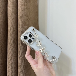 Close-up of a clear luxury iPhone case with a sparkling rhinestone chain strap