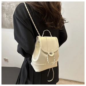 Detail of off-white leather mini backpack featuring woven chain straps and metal twist lock