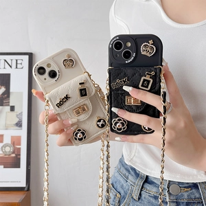 Detail view of quilted leather wallet phone case with gold crown and camellia charms