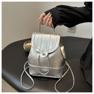 Detail of silver mirror mini bucket bag with chain strap and metallic finish