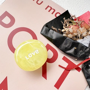 Detail of yellow marble phone socket with Love text and decorative dried flowers