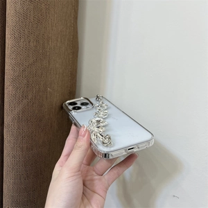 Macro shot of silver rhinestone bracelet attached to a clear protective phone case