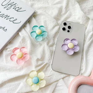 Close-up of translucent floral phone griptoks in purple, pink, blue, and yellow colors